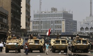 Soldiers stand guard on armoured personnel carrier positioned outside Ramses Square, near al-Fath mosque in Cairo